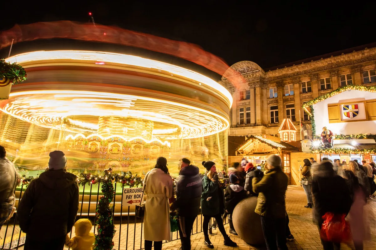 Mugs of steaming Glühwein and festive treats at a Frankfurt Christmas market stall
